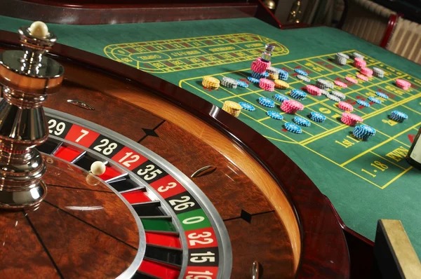 Live poker table with dealers and players at bet1